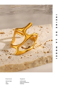 Detail of irregular golden organic ring on stone base with artistic modern sculpture style