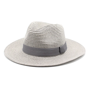 Detail of light beige straw fedora hat with a grey satin ribbon and fine woven texture
