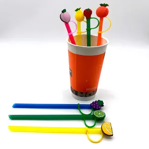 Colorful silicone straws set with fruit dust caps featuring peach strawberry and lemon