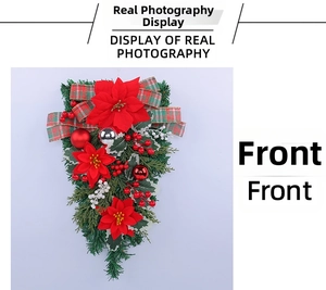 Close-up of Christmas upside-down tree wreath with red poinsettia and festive bow