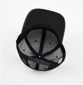 Internal view of black mesh trucker hat showing breathable structure and snapback closure