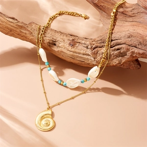 Double-layered gold necklace with turquoise beads, white shells, and a conch pendant