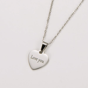Detail of silver heart pendant with Love You engraving on a delicate O-chain