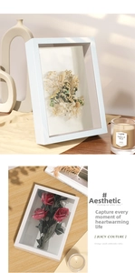 Detailed view of white 3D shadow box frames featuring dried flowers and fabric lining