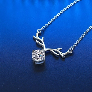 Elegant silver antler pendant necklace with a round moissanite stone on a blue background