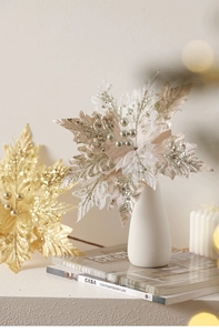 Champagne gold artificial poinsettia flower with sequins in a ceramic vase for Christmas decor