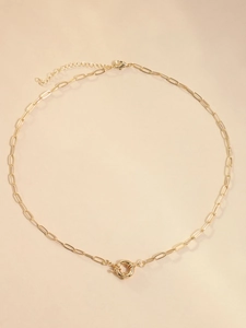 Detail of 18K gold-plated paperclip chain necklace with a central spring ring clasp