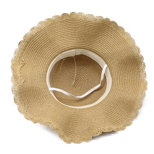 Detail of the inner straw weave, white sweatband and elastic chin strap of the sun hat