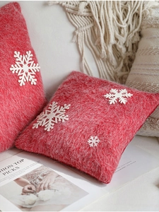 Detailed view of red Christmas pillow featuring white 3D snowflake on mohair fabric