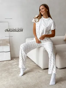 Detail of soft ribbed fabric women's pajamas with red floral heart print and round neck