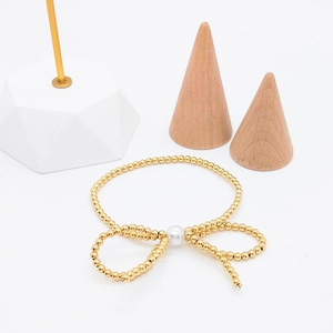 Elegant 18K gold bead bracelet with central white pearl and stylish bowknot design