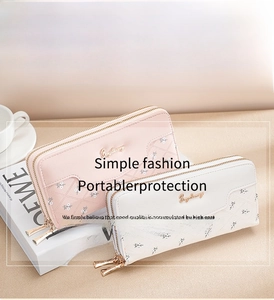 Detail of pink and white quilted PU leather long wallets with floral embroidery