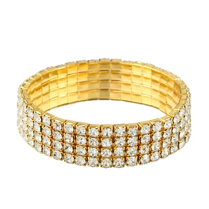Elegant four-row gold elastic bracelet with shimmering white crystals on white background