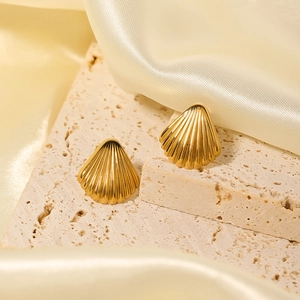 Elegant 18k gold plated shell shaped titanium steel stud earrings on beige stone