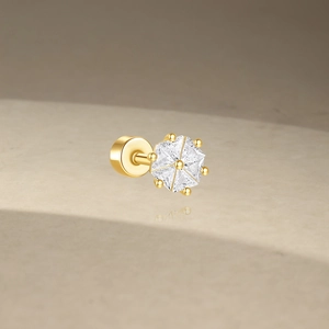 Macro shot of gold S925 silver cartilage stud with sparkling cubic zirconia inlay