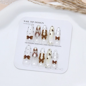 Handmade cat-eye press-on nails with leopard print, 3D bows, and rhinestone accents
