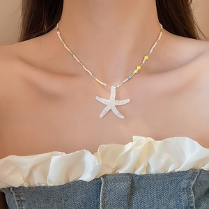 Close-up of iridescent resin starfish pendant on colorful beaded vacation necklace