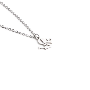 Polished stainless steel LOVE pendant necklace on silver cable chain against white background