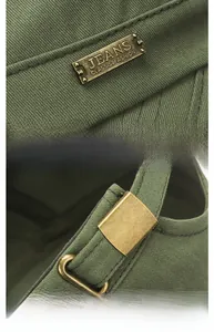 Detailed view of canvas army green flat cap featuring metal brand tag and adjustable buckle