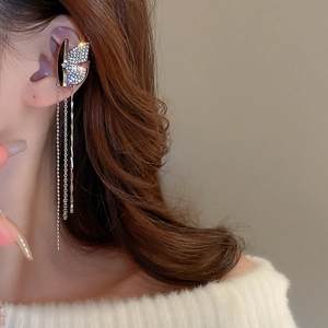 Detail of silver butterfly ear bone clip with sparkling rhinestones and long tassel chains