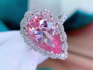Macro shot of 7.5ct pear-cut pink gemstone ring with double-layered diamond halo detailing