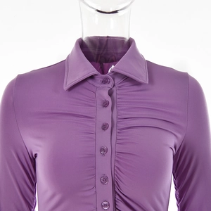 Detail of purple ruched long sleeve shirt with turn-down collar and button-down front