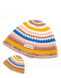 Detail of colorful striped beanie featuring a Love Fashion label and fringe hem accents