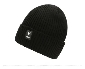 Detail of black winter beanie featuring thick knit texture and sporty V SPORTS logo tag