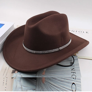 Detail of dark brown felt cowboy hat with silver rhinestone band on Kinfolk magazine