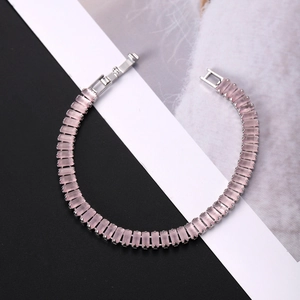 Detail showing high-quality pink rectangular gemstones set in silver metal tennis bracelet