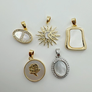 Detailed macro view of natural shell pendants with gold plating and cubic zirconia