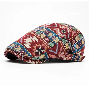 Detail of burgundy ethnic flat cap showing bohemian geometric patterns and side metal buckle