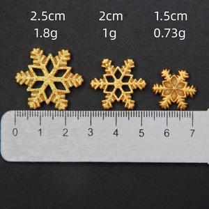 Golden glitter snowflake charms in three sizes for DIY crafts and holiday decor