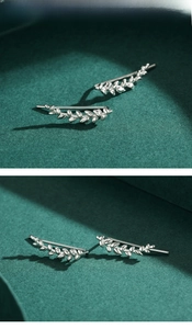 Macro view of S925 sterling silver leaf ear cuffs with polished metallic finish