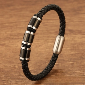 Detailed macro view of black braided leather men's bracelet with silver magnetic metal clasp
