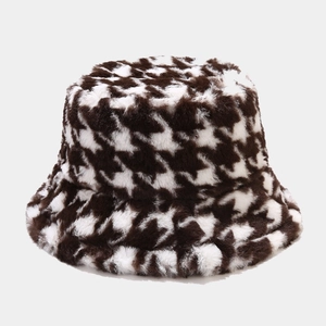Detailed view of the brown and white houndstooth plush fabric on this winter bucket hat