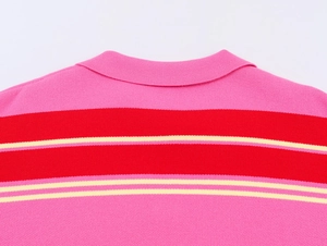 Close-up of the ribbed collar and pink, red, and yellow striped knit pattern on the polo shirt