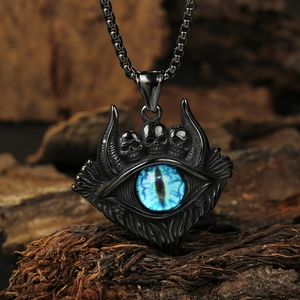 Macro shot of punk style evil eye pendant with skulls and blue eye stone details