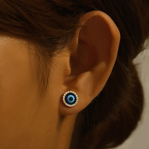 Close-up of S925 silver evil eye stud earring with blue stones and sparkling crystals