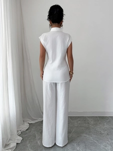 Elegant white sleeveless stand collar shirt and wide-leg linen trousers set for women