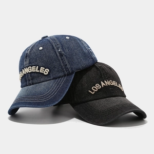 Vintage denim blue and black baseball cap with Los Angeles embroidery on gray background