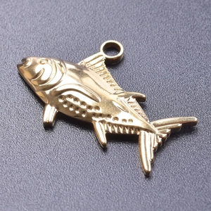 Macro shot of 18k gold-plated stainless steel fish pendant accessory for DIY necklaces