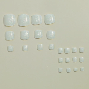 Sparkling white glitter press-on toenails set in 24 pieces on neutral background