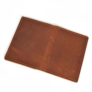 Brown crazy horse leather passport wallet with vintage texture on a white background