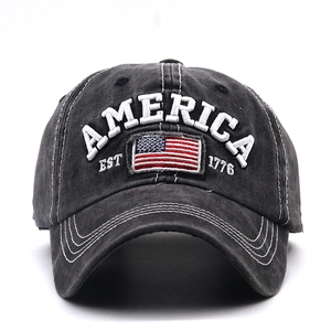 Close-up of AMERICA 3D embroidery and flag patch on washed black baseball cap