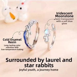 Detail of angel and demon couple rings with moonstone and blue enamel accents