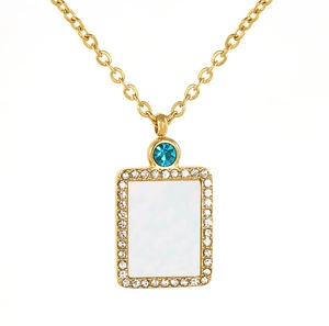Detailed view of rectangle gold pendant with white shell inlay and blue gemstone