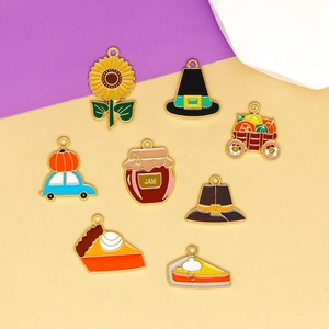 Flat lay of Thanksgiving enamel charms including pumpkin pie and jam for DIY jewelry making