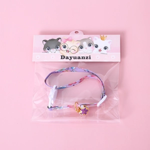 Purple floral pet collar with gold bell and adjustable buckle in cartoon packaging