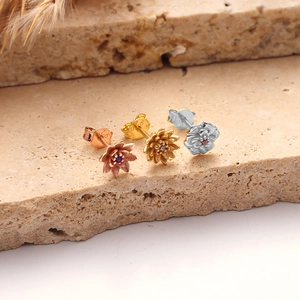 Close-up of 925 sterling silver hallmarked earrings in rose gold and silver finishes